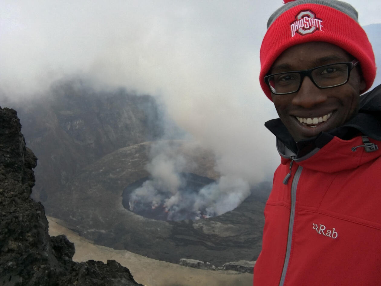 Christopher Aiden-Lee Jackson in front of a volcanic crater.