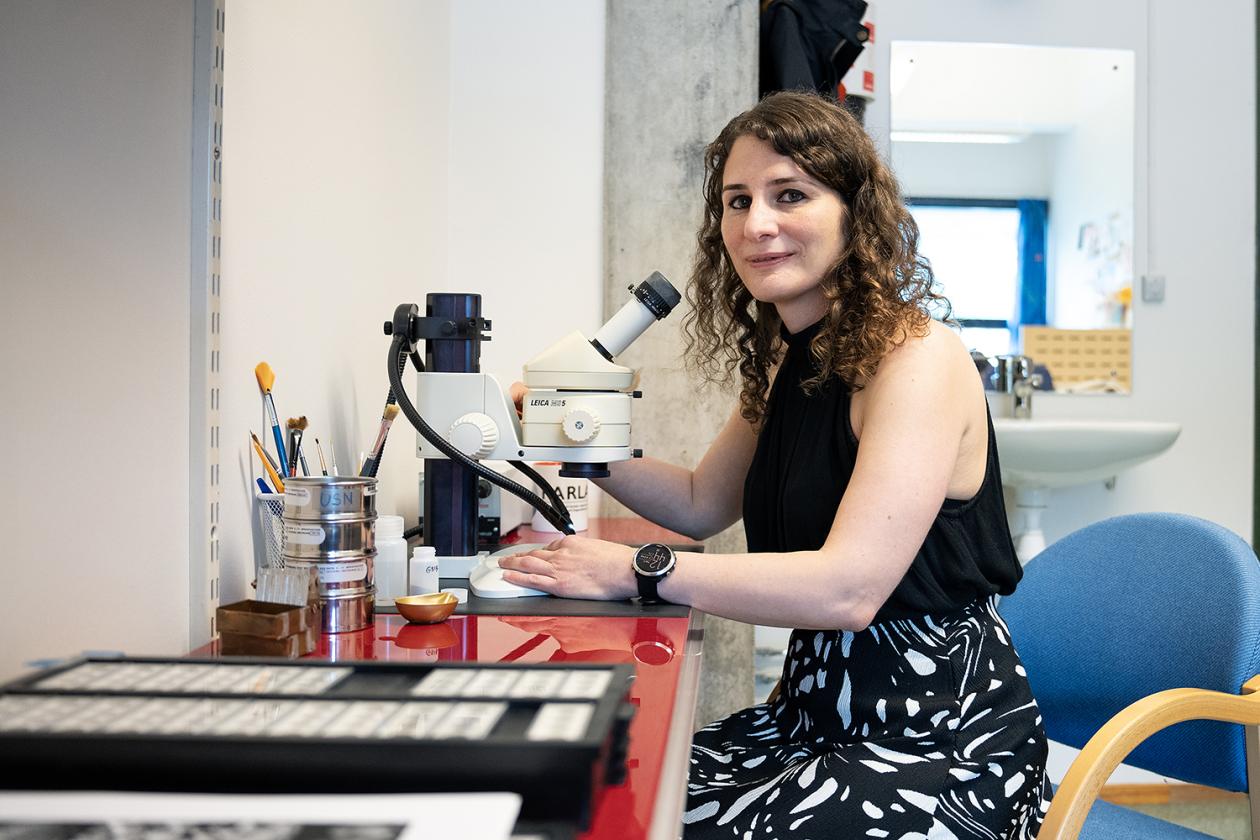 Nil Irvali with her microscope at her office