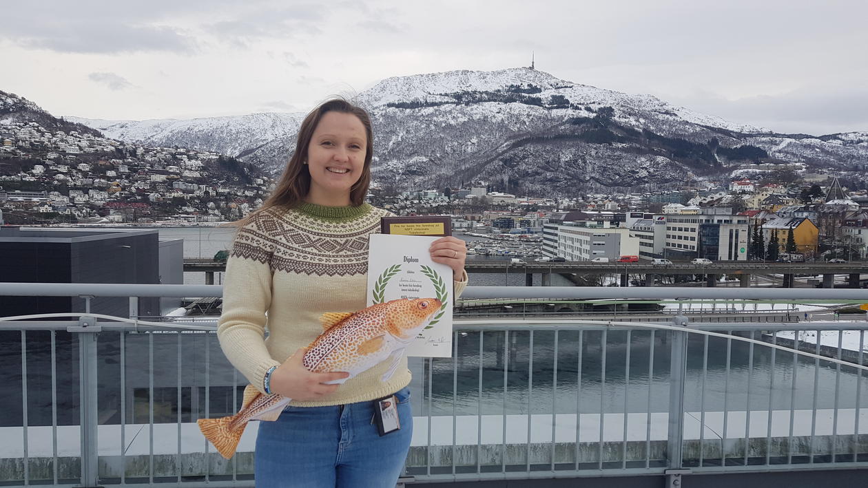 Karina Dale posing with an Atlantic cod and a diploma