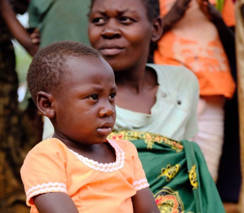 The photo shows an African mother and her young daughter. 