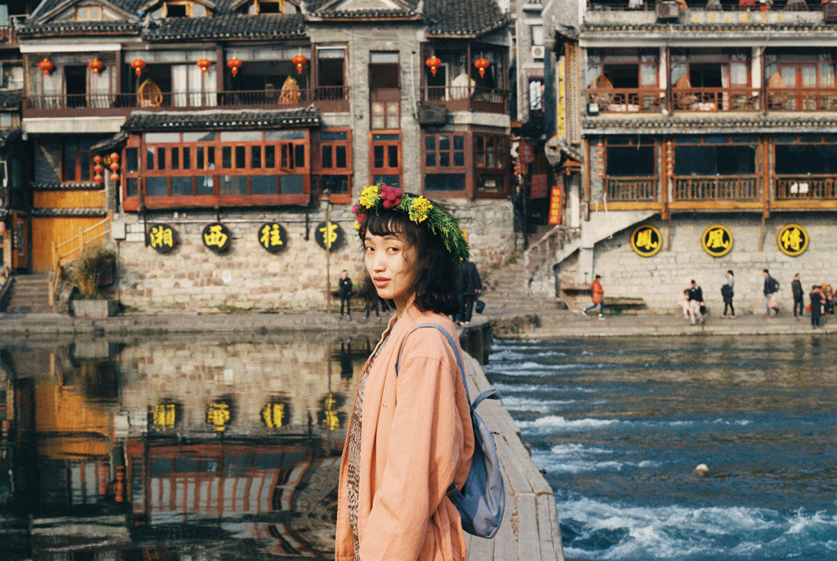 Girl by a river in Fenghuang, China