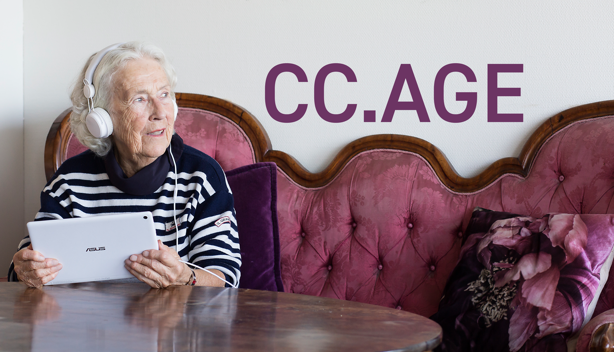 Elderly lady with a tablet and headphones.