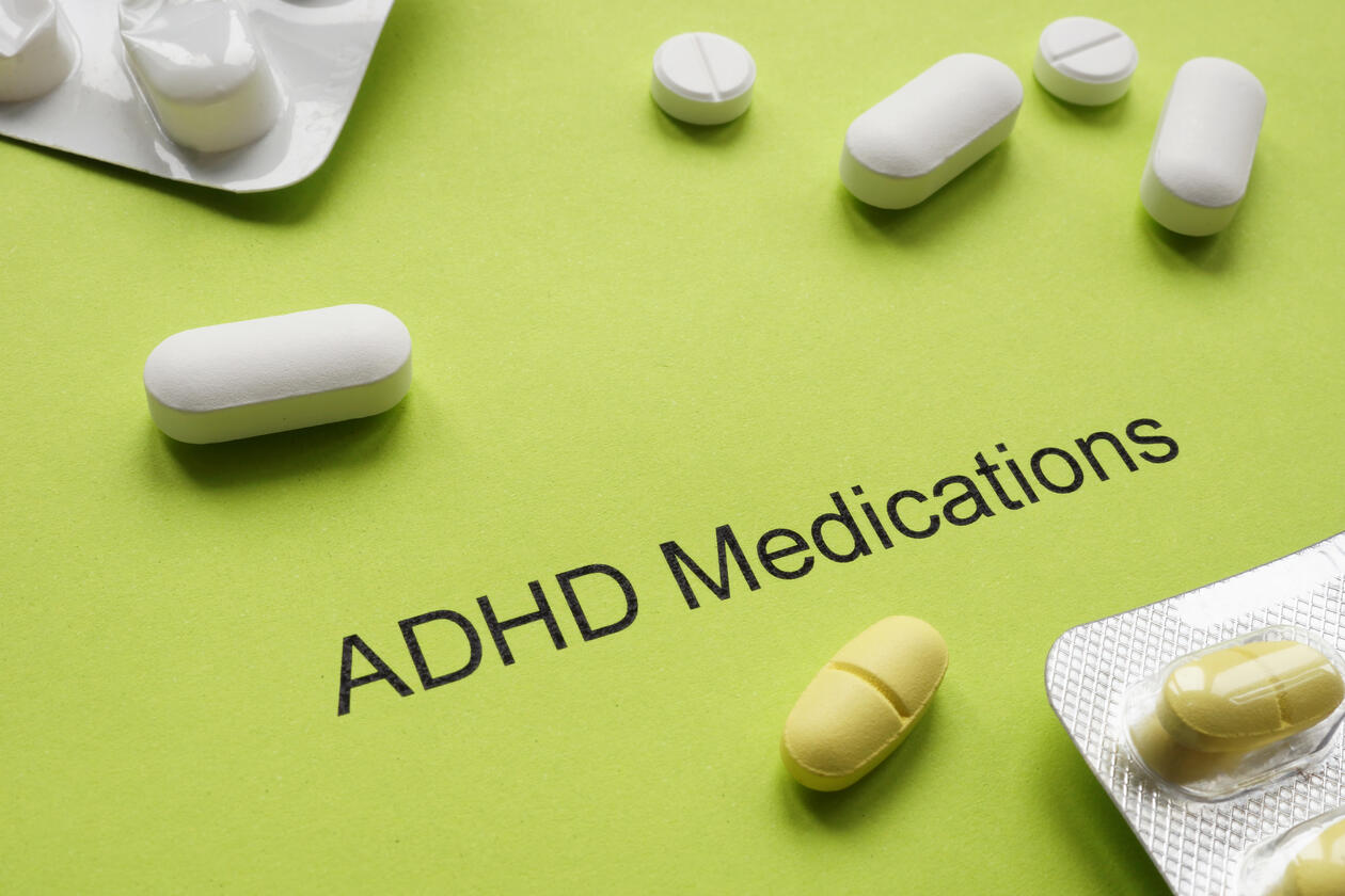 Green sheet of paper with an inscription ADHD medications and pills.