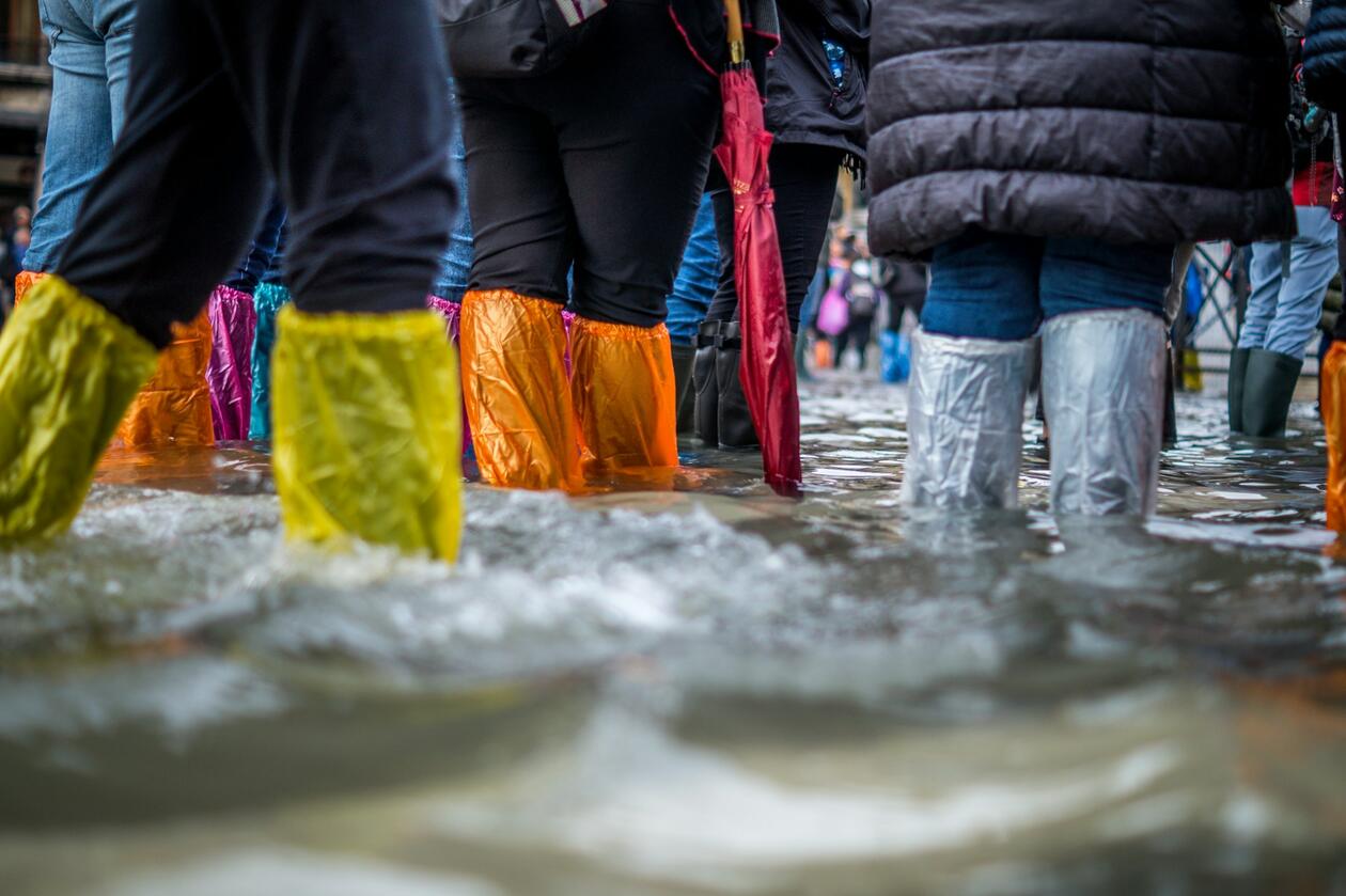 Tourists try to stay dry in a flooded St Mark’s Sq, Venice.