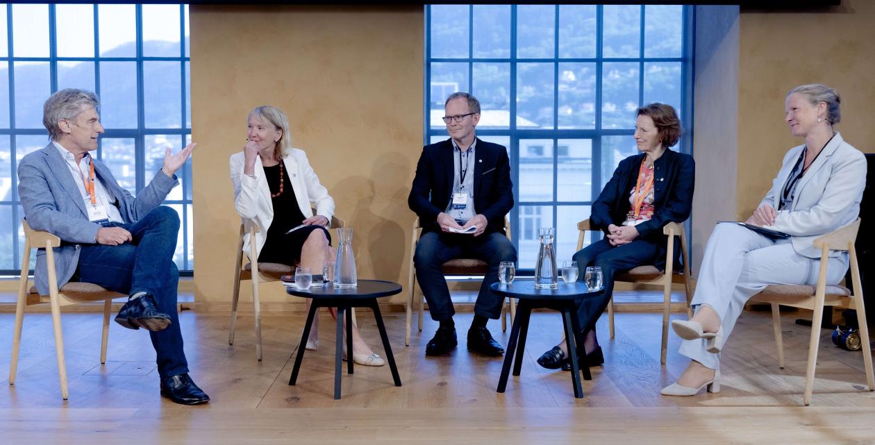 Panelsamtale i universitetsaulaen med fem deltakere