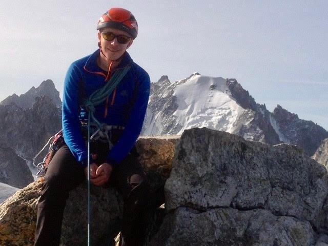 Richard Payne in climbing gear sitting on a rock 