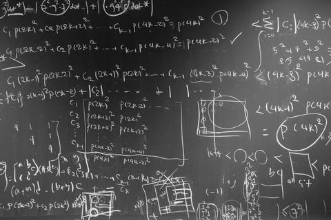 Image of blackboard with algorithms written all over it.