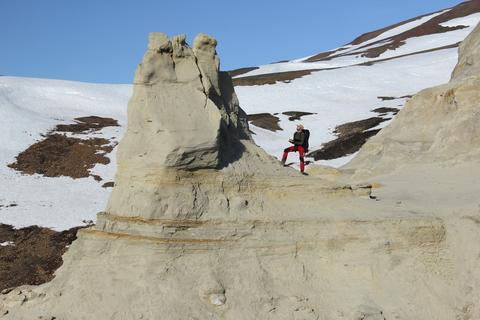 Picture showing Gijs investigation an outcrop section consisting of stacked turbidite beds