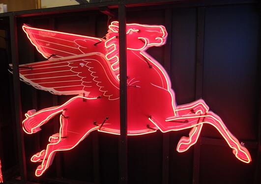 A red neon sign of a pegasus
