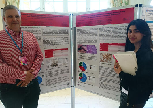 Andrey and Gayanna standing in front of their posters.