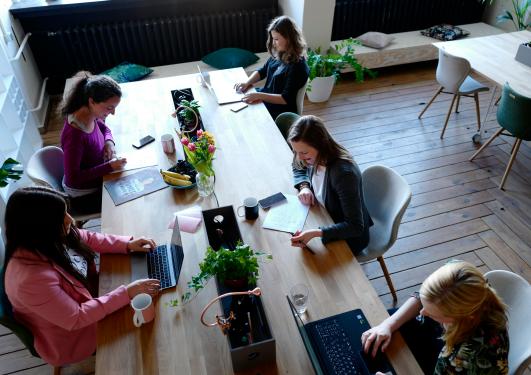 Group of people discussing around a table