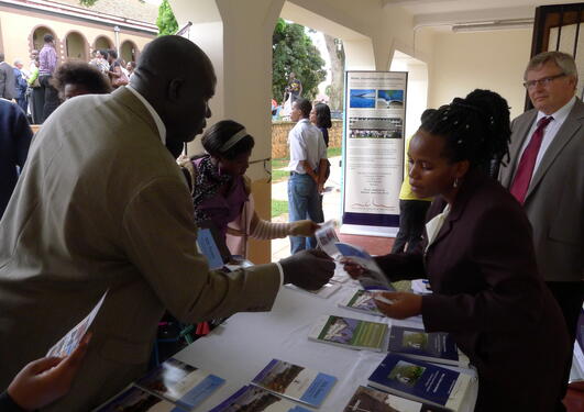Tore Sætersdal at Makerere University in Kampala, Uganda in spring 2013, at a stand with books and pamphlets on the Nile and research on water.