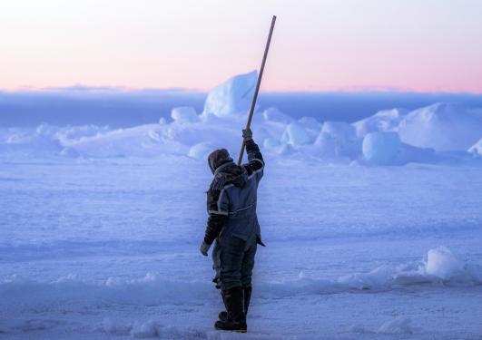 Sea ice fisherman checking the sea ice if it is safe.